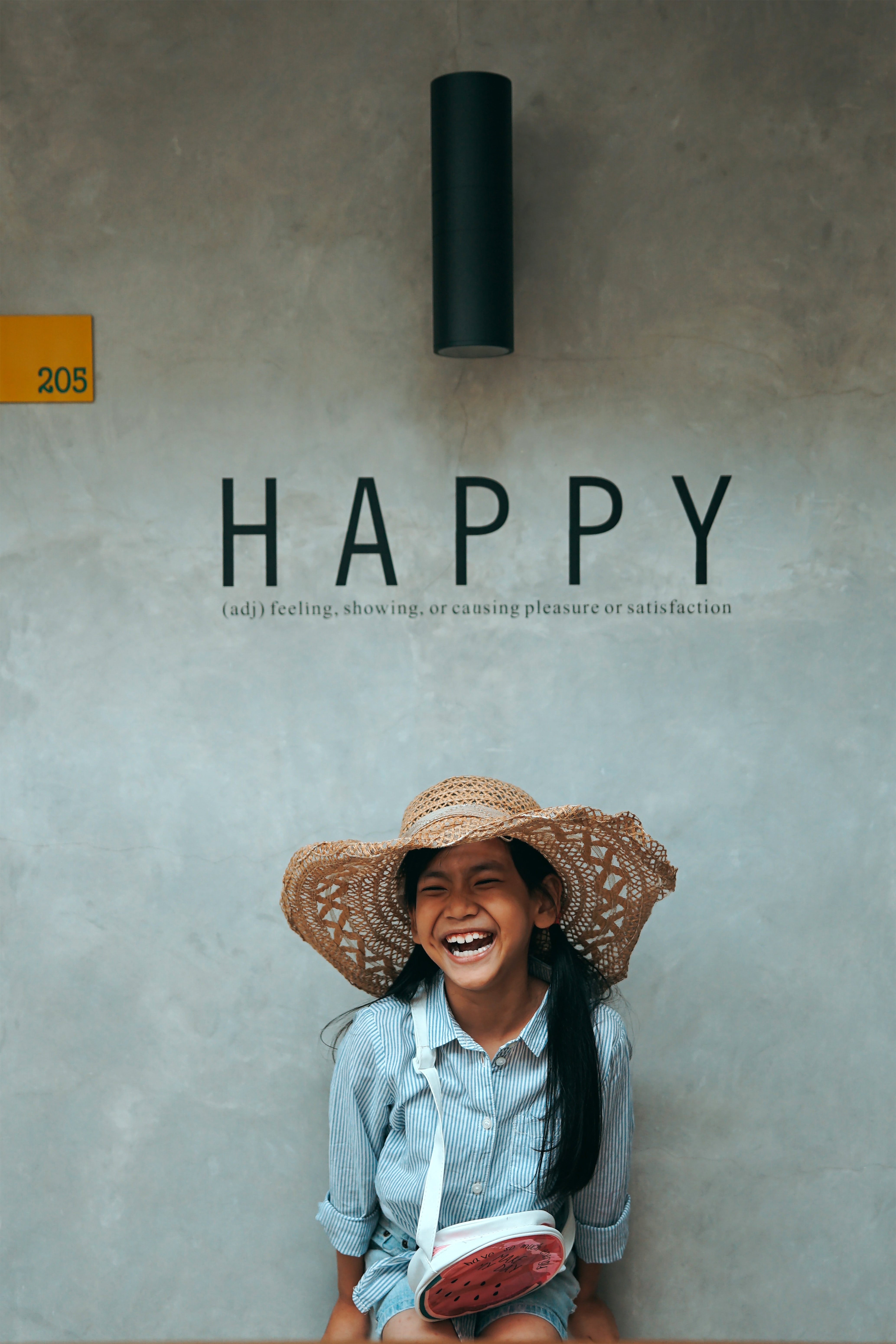 young girl smiling with the text happy and definition